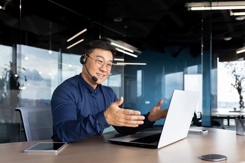 asian with a headset is talking on video call man e1729863276458.jpg