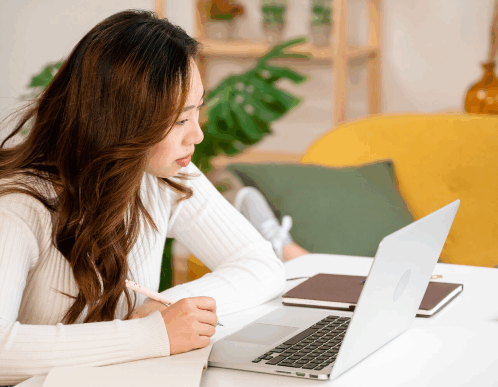 focused asian woman working on laptop 2023 11 27 05 11 41 utc 1 horiz